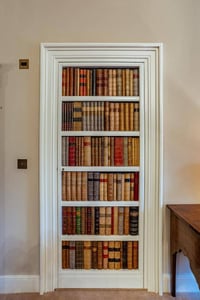 A hidden door behind a well-stocked bookcase